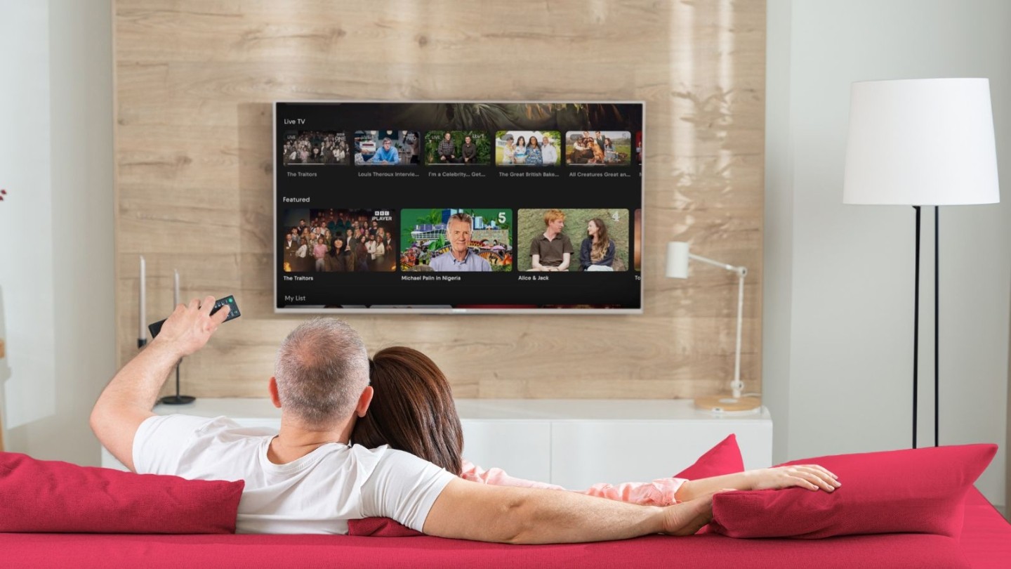Couple watching Freely TV from their sofa