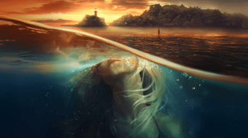 Split-view image showing a woman underwater with her head tilted back toward the surface, illuminated by soft light. Above the waterline, a calm sea reflects a dramatic sunset with an island and lighthouse in the distance. 
