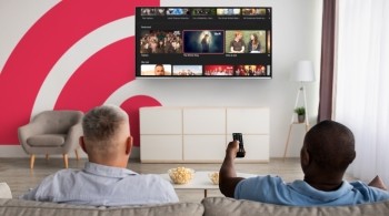 Two people watching a Freely TV from their sofa