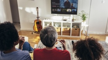 Three people watching a Freely TV