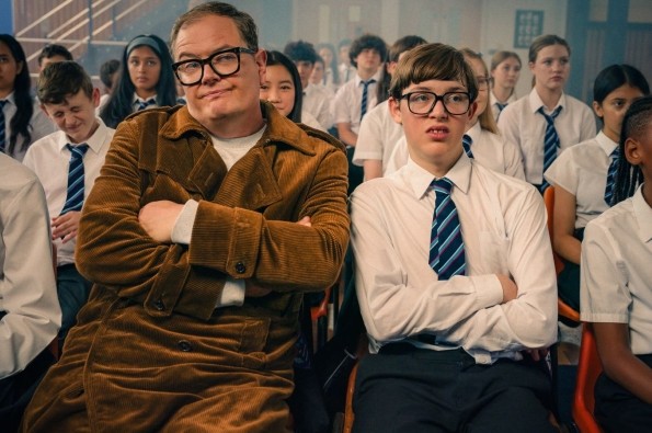 Alan Carr and Oliver Savell playing Alan Carr sat in school uniform in the comedy Changing Ends