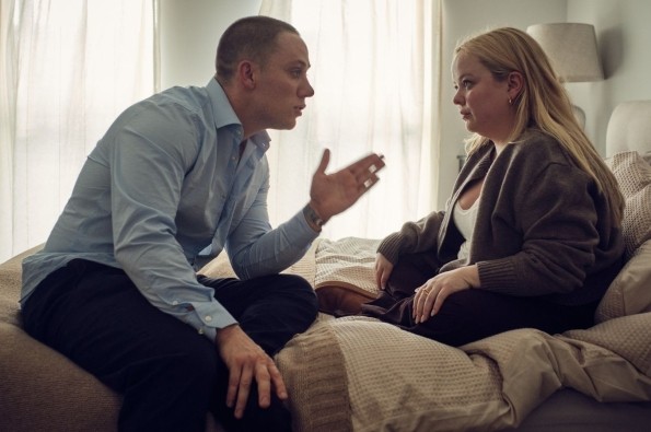 I Am Helen promotional image featuring two people sitting on a bed in a softly lit bedroom, engaged in an intense conversation, highlighting themes of personal relationships, emotional conflict and contemporary drama.