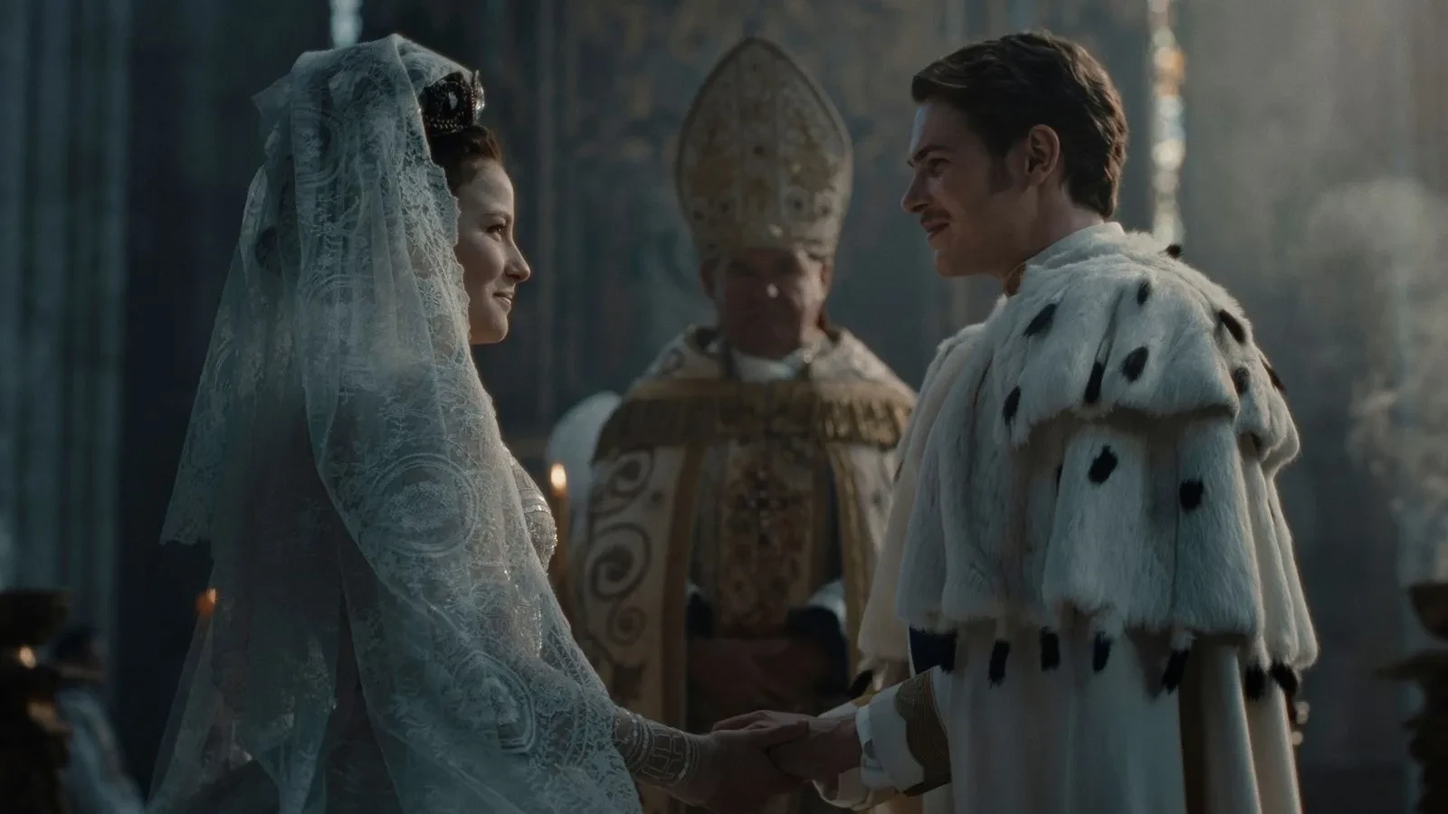 Key art for The Empress, a women in a wedding veil and a man in a royal wedding outfit with a priest between them
