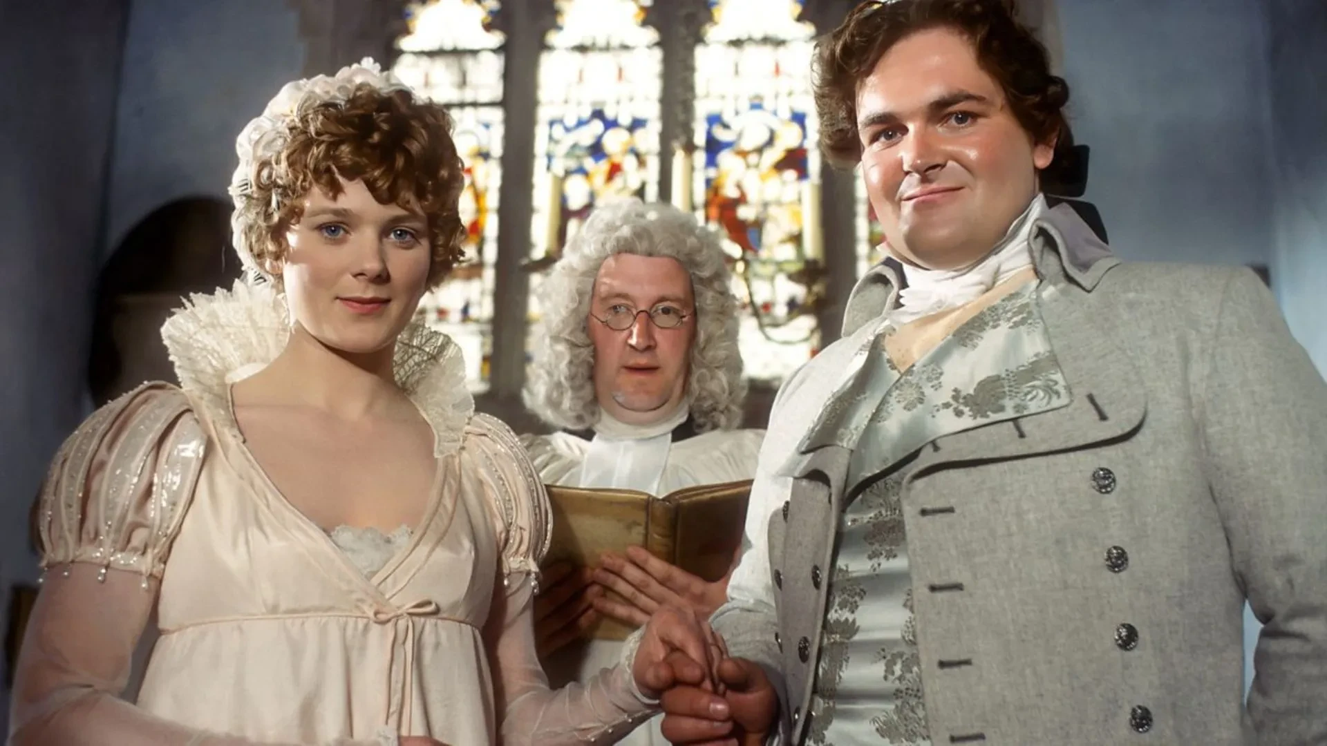 A man and woman in Regency-era wedding attire stand hand in hand before a clergyman holding a book; still image from the 1983 TV adaptation of *Mansfield Park*.
