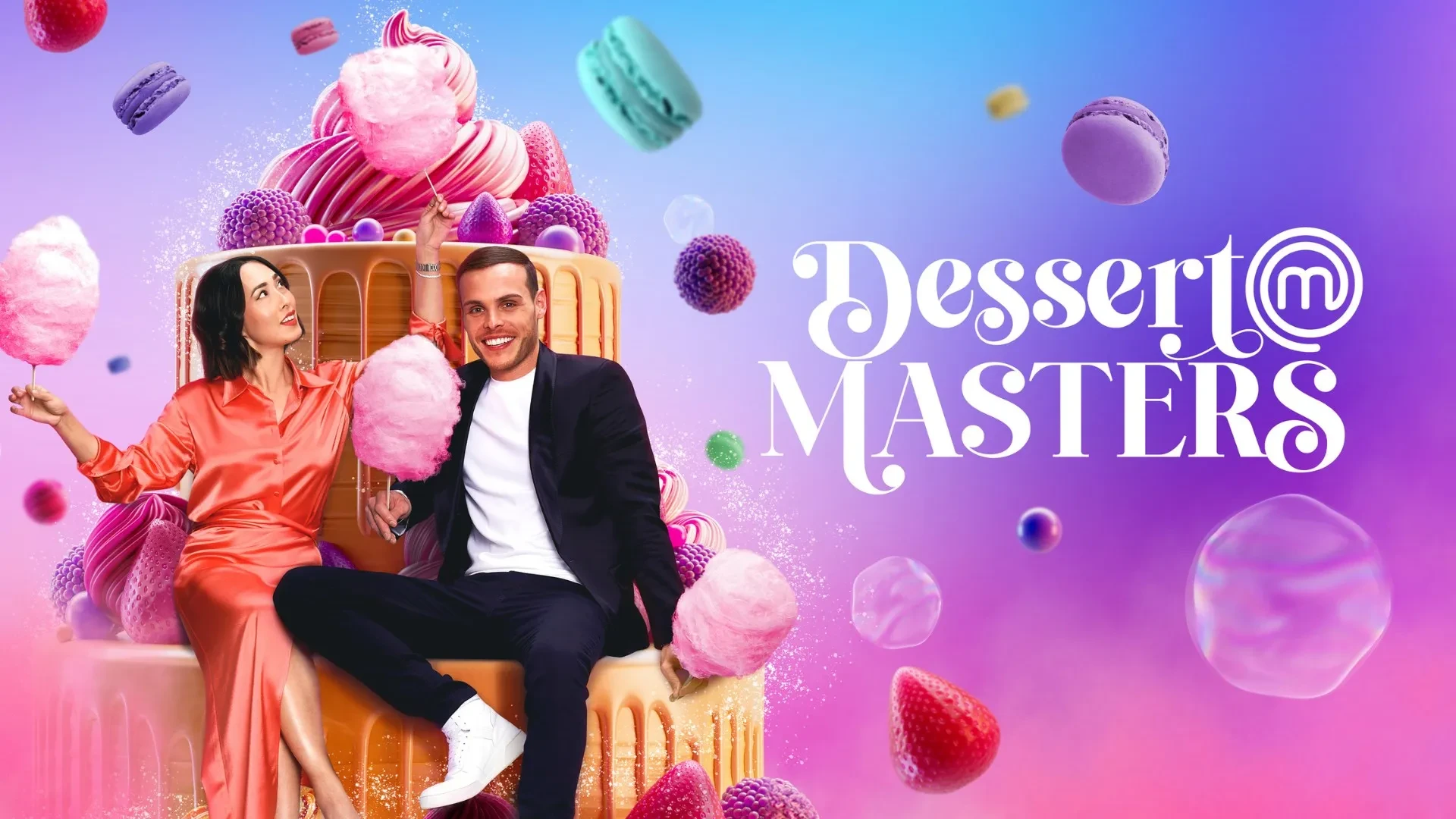 Two people sitting on an oversized dripping cake, holding fluffy pink candyfloss, surrounded by vibrant macarons, berries and sweets against a colourful gradient background, with the “Dessert Masters” logo displayed prominently.