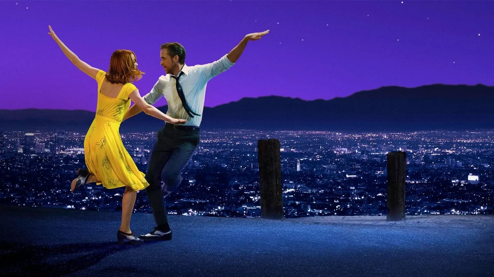 Two people dancing on a hilltop at night, with a city skyline lit up below and a deep purple starry sky in the background. One wears a bright yellow dress, the other a white shirt with dark trousers and braces.