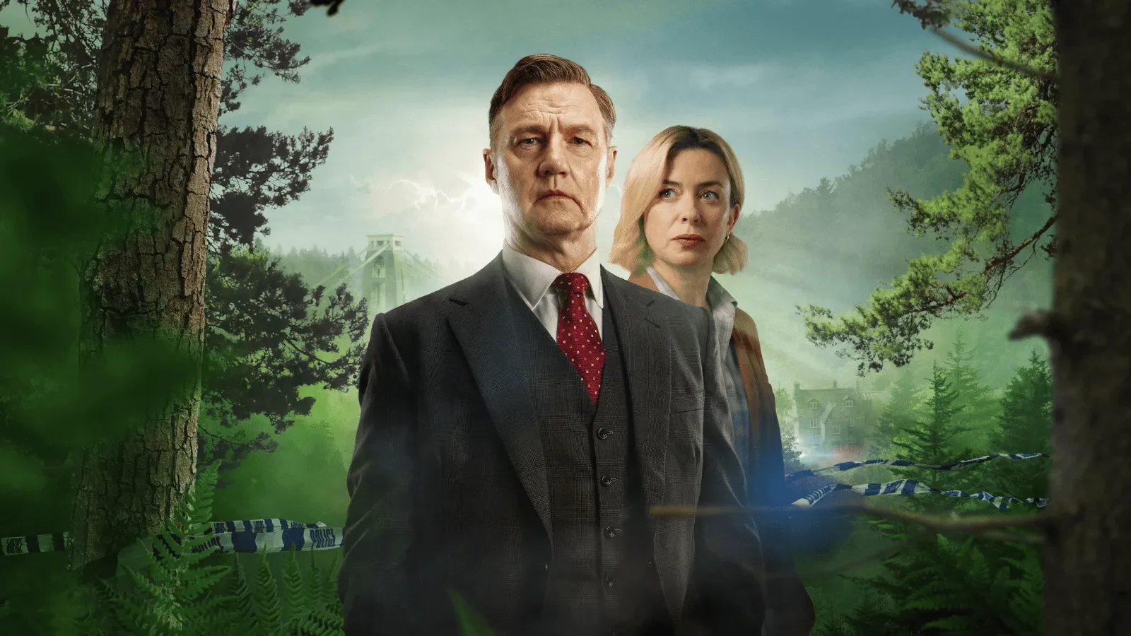 Two individuals in formal clothing standing in a forest clearing with a large bridge and misty hills in the background, creating a mysterious and dramatic atmosphere.