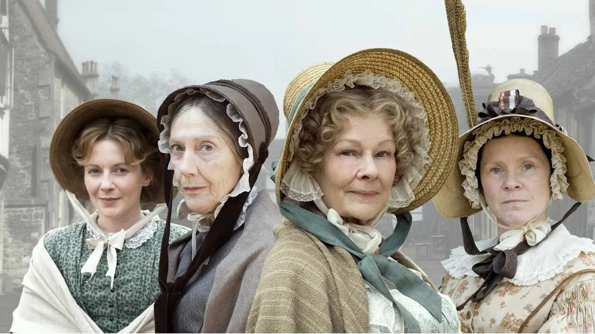 Cast portrait from Cranford featuring characters in Regency‑era bonnets and dresses set on a traditional English village street.