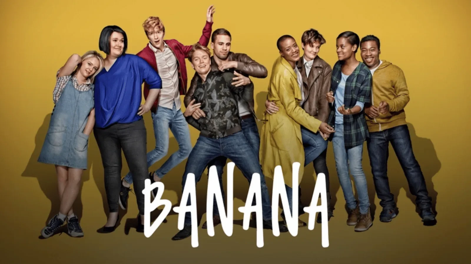 a group of young adults posing in front of a yellow background with writing that reads "banana"