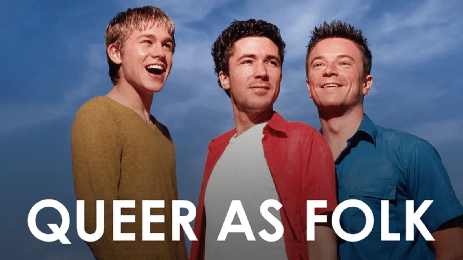 Three young men stood against a blue sky staring into the distance with writing that reads "Queer as folk"