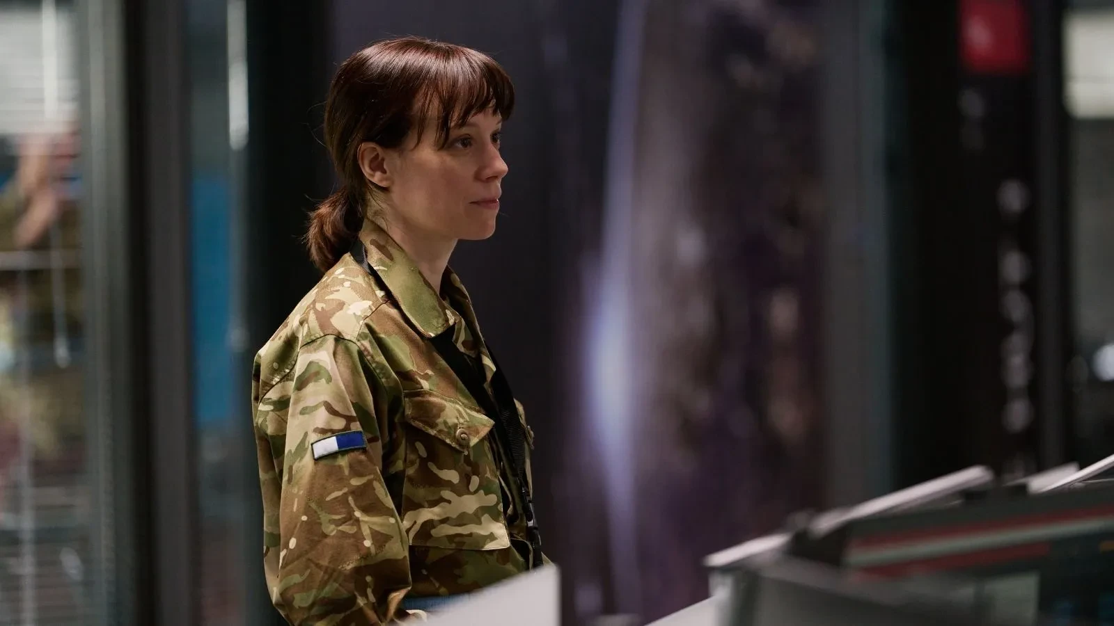 Individual in military camouflage uniform at a secure intelligence facility in The Undeclared War, highlighting national cybersecurity and defence operations