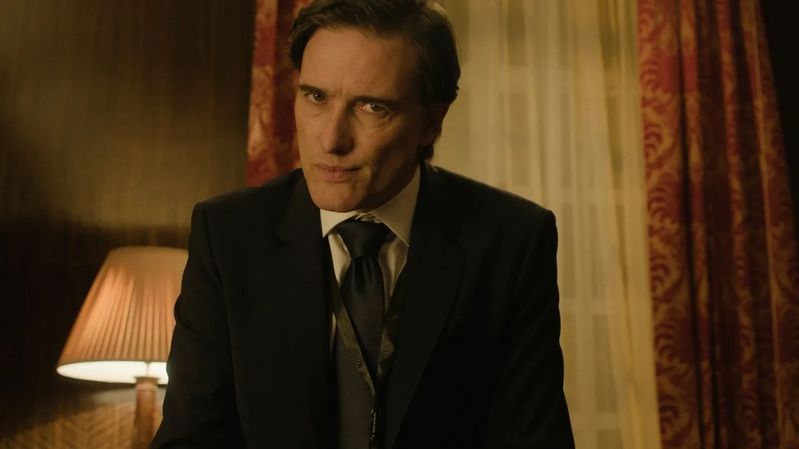 Close up of government official in an office looking at the camera in the show Undeclared War
