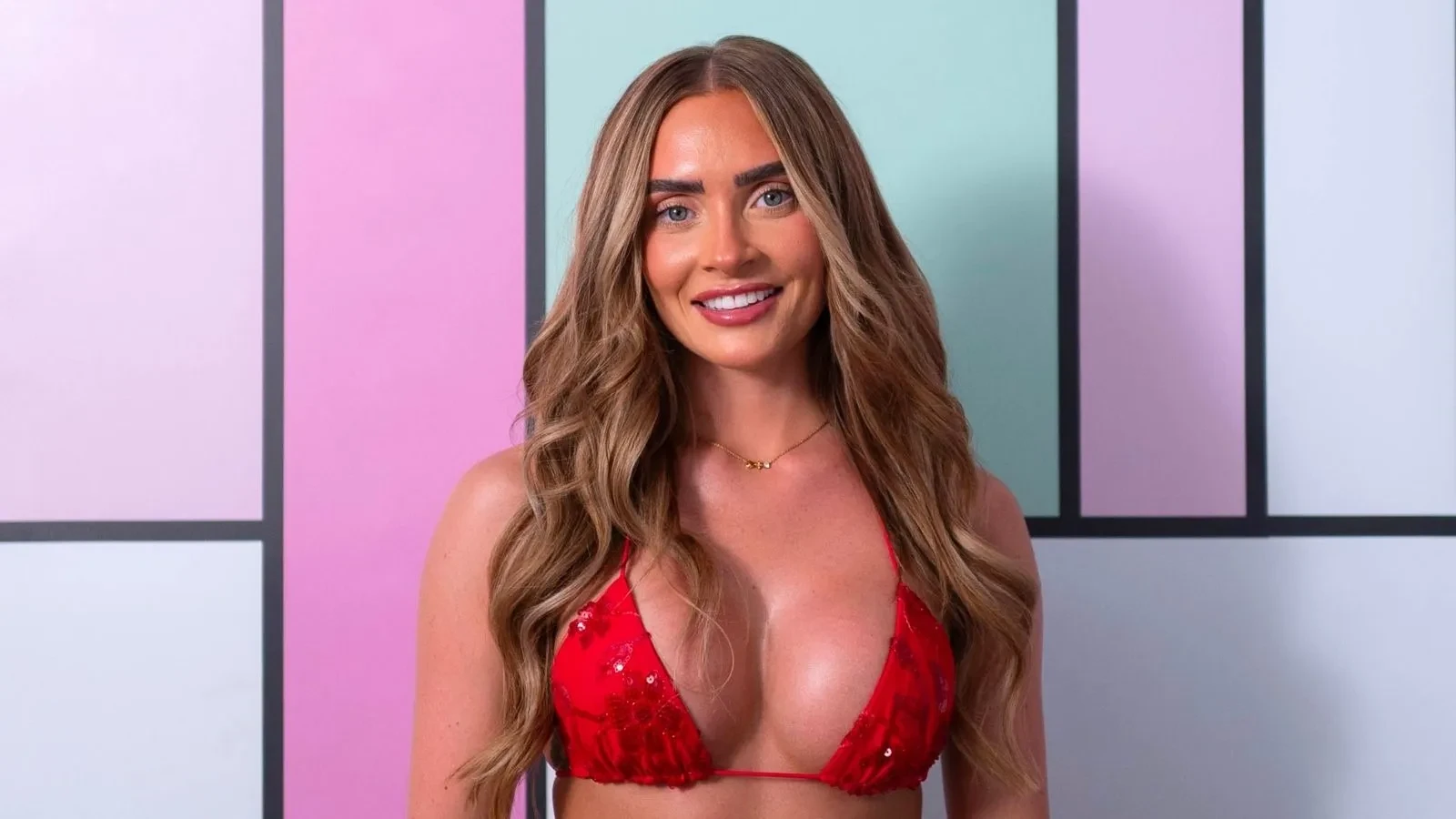 Elicia Bailey in a red bikini against the colourful Love Island background