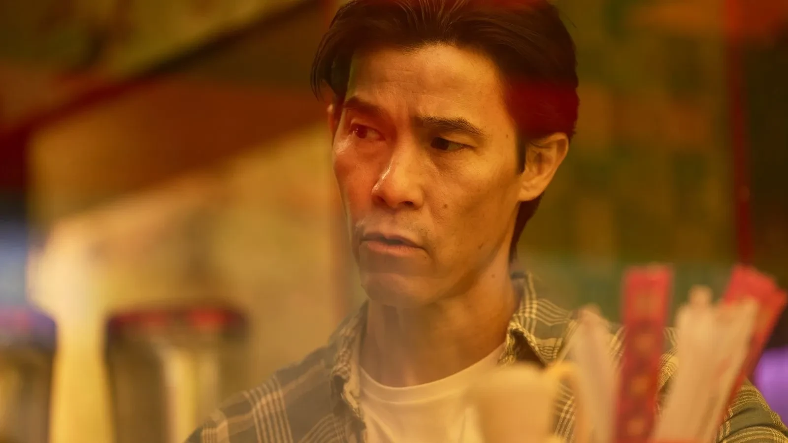 Close up of Jason Tobin as Mr.Lao in a promotional image for the TV show Undeclared War
