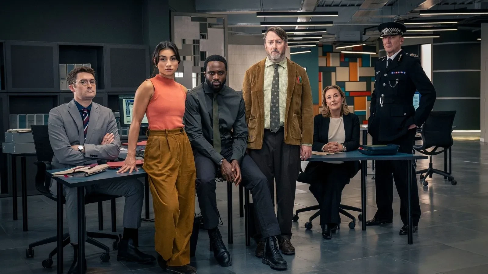 Promotional image for seaosn 2 of Ludwig. Group of detectives in a grey office looking into the camera
