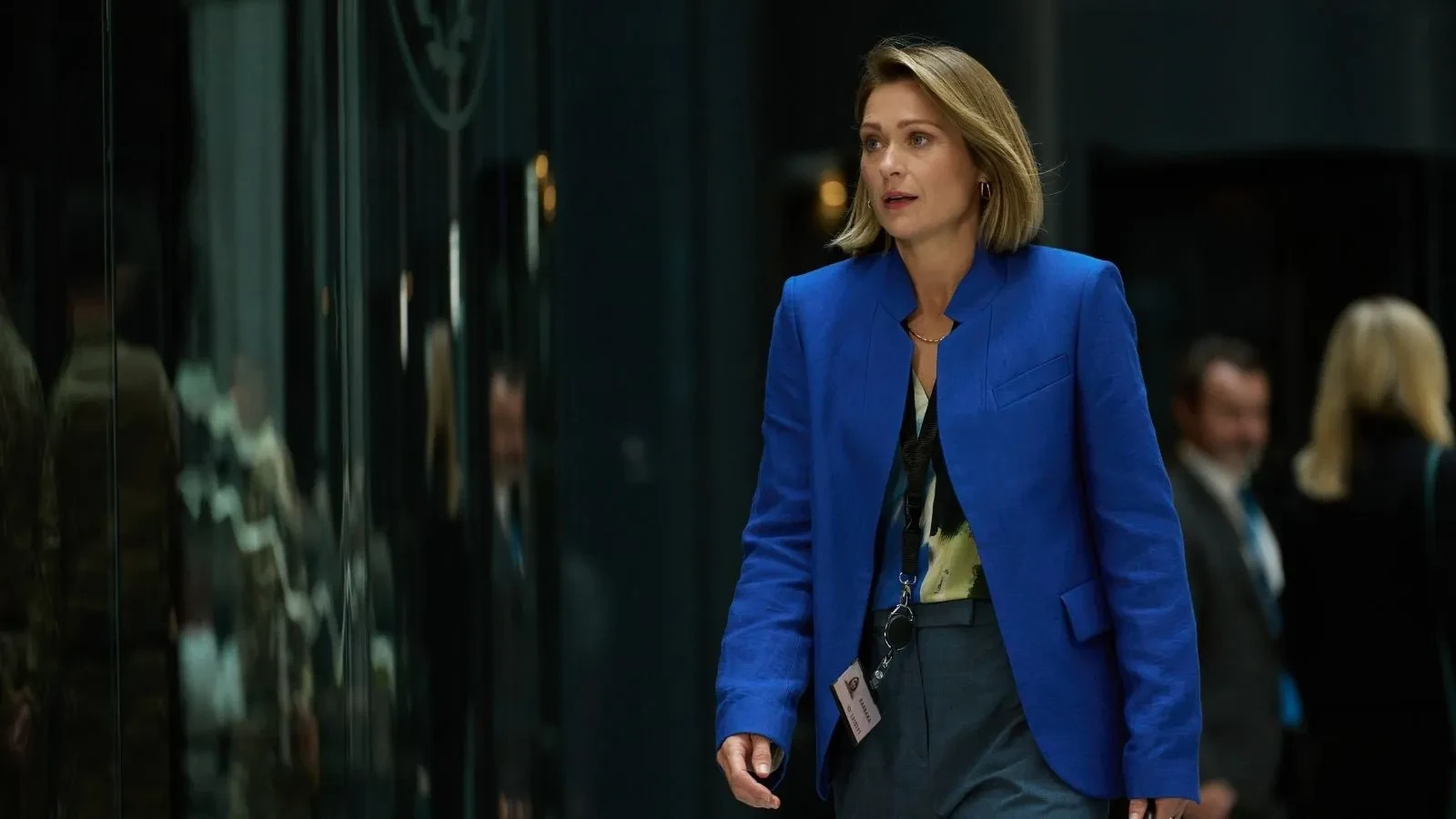 Government representative walks through a secure operations centre coordinating responses to a major cyberattack in The Undeclared War.
