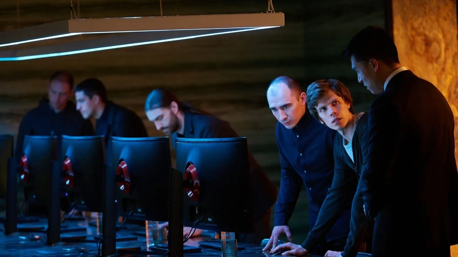 Cybersecurity analysts monitoring multiple computer screens in a high-tech operations center during a cyber incident response investigation.