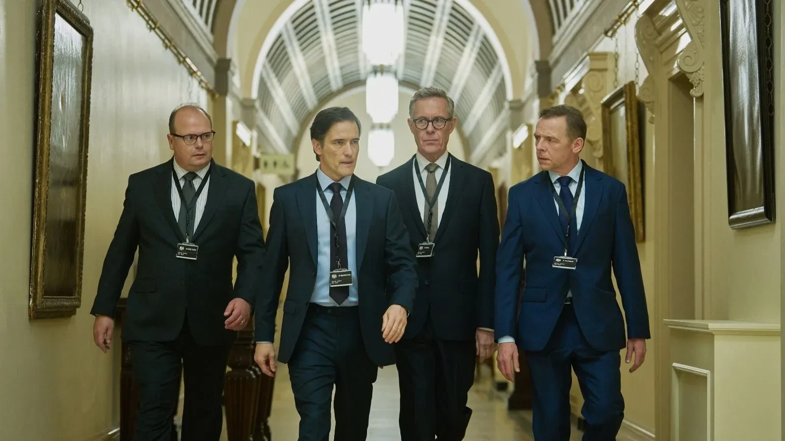 Officials from a national security and intelligence team move through a government building while responding to a major cyberattack in The Undeclared War TV series.