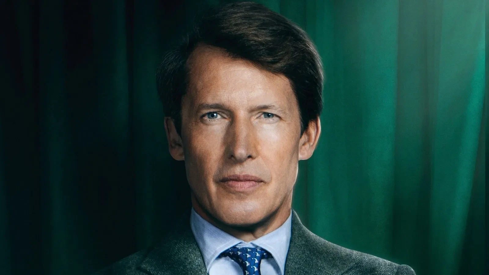 James Blunt stood against a green backdrop in Celebrity Traitors