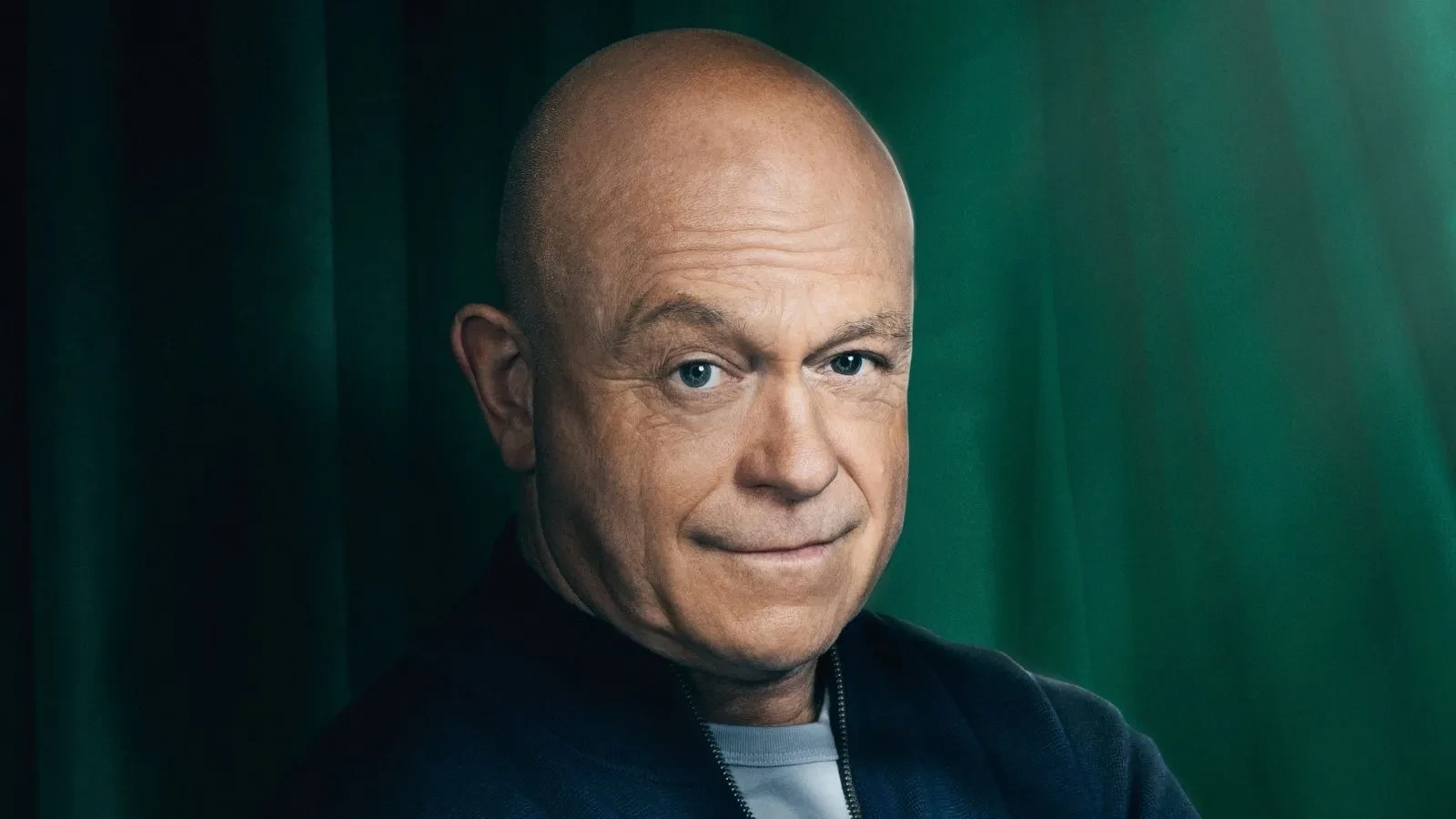 Ross Kemp stood against a green background in Celebrity Traitors