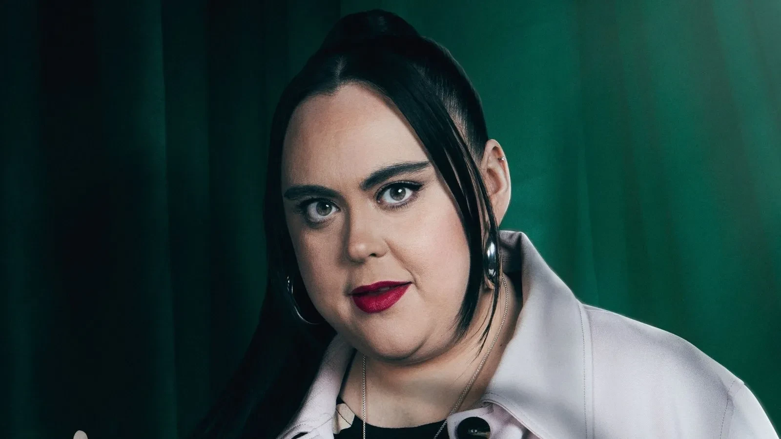 Sharon Rooney stood against a green background in Celebrity Traitors