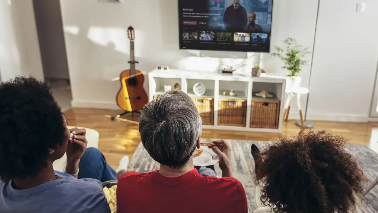 Three people watching a Freely TV