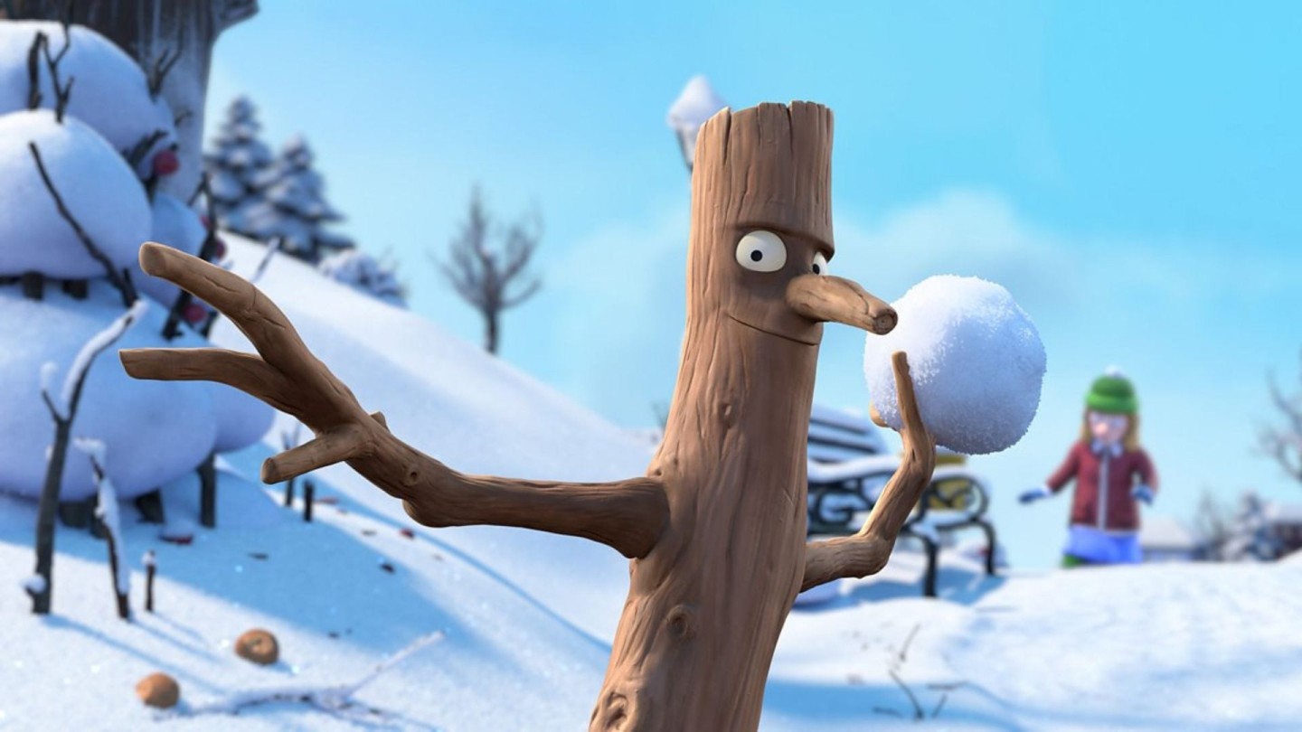 Promotional art for the film “Stick Man”, showing an animated stick character holding a snowball in a snowy outdoor setting with trees and a snow-covered house in the background.
