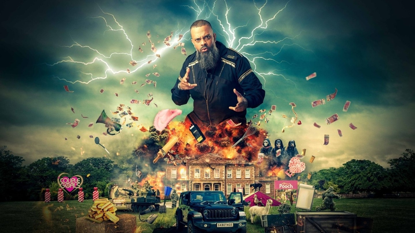 A bald man with a beard on top of an exploding house with lightening behind him and a chaotic scene below