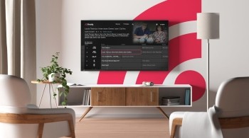 Freely TV guide on TV mounted on wall with pink Wi-Fi in background