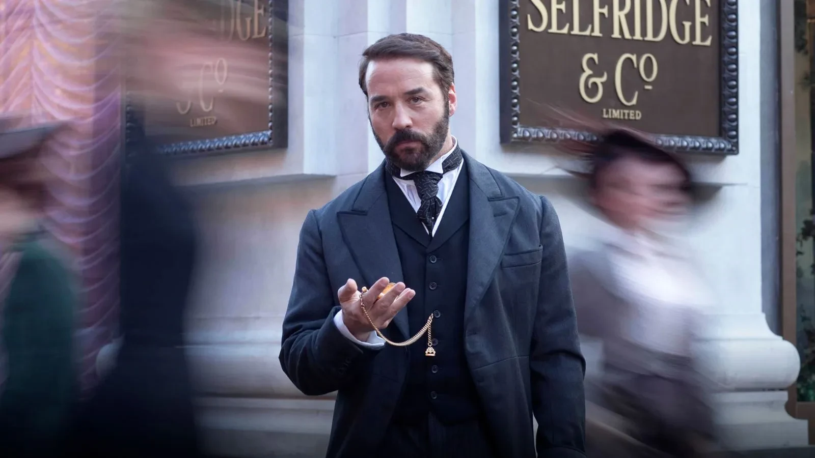 Man holding pocket watch in period clothing