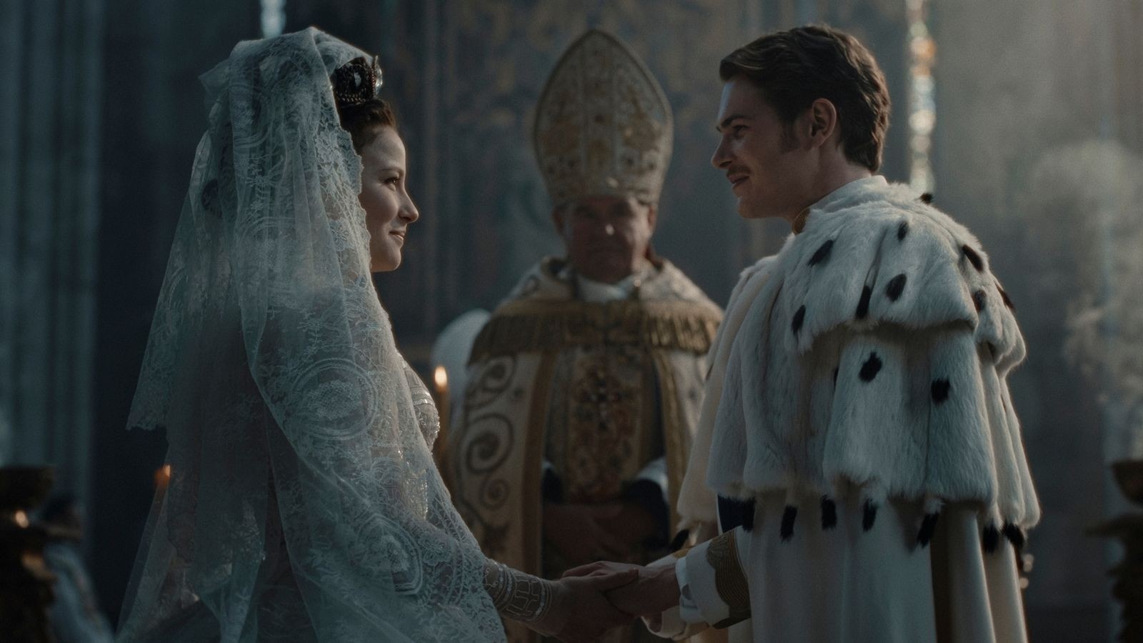 Key art for The Empress, a women in a wedding veil and a man in a royal wedding outfit with a priest between them