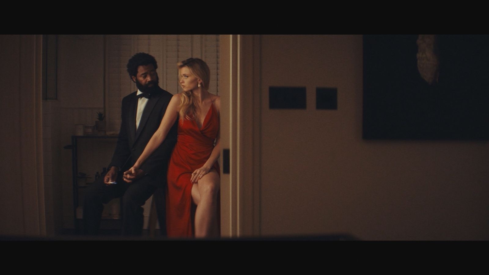 A man in  black suit and a women in a red dress