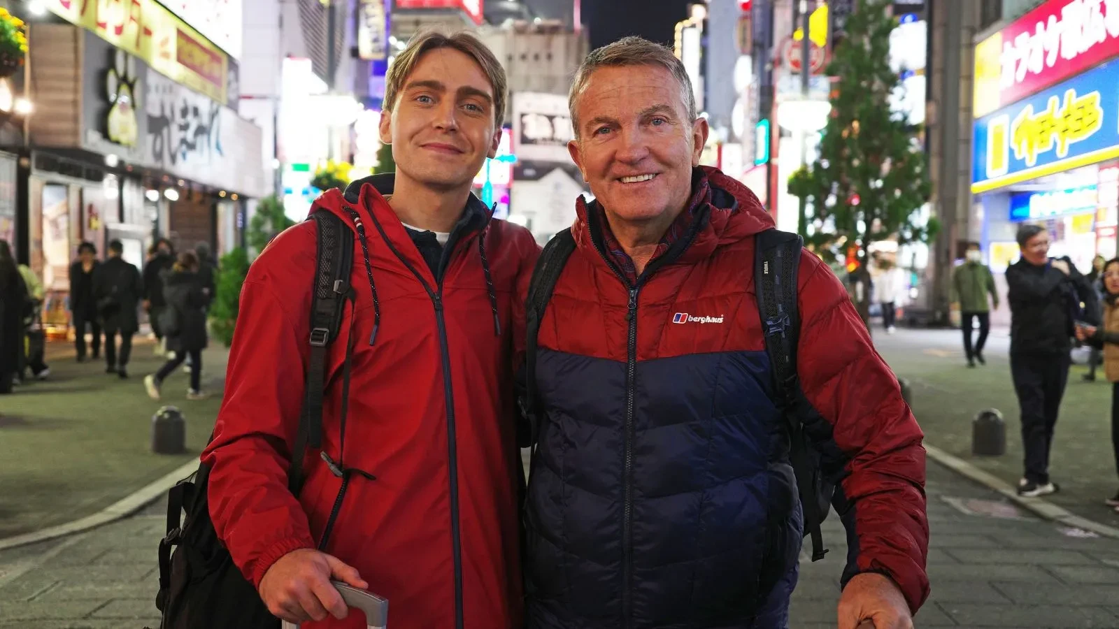 Bradley and Barney Walsh wearing red jackets in a highstreet