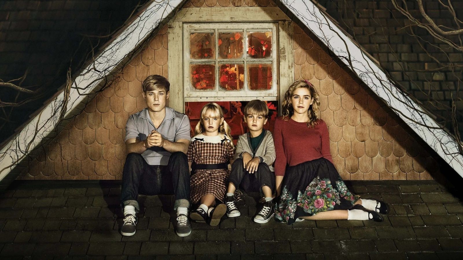 Two older children and two younger children sat on a roof outside a window to an attic