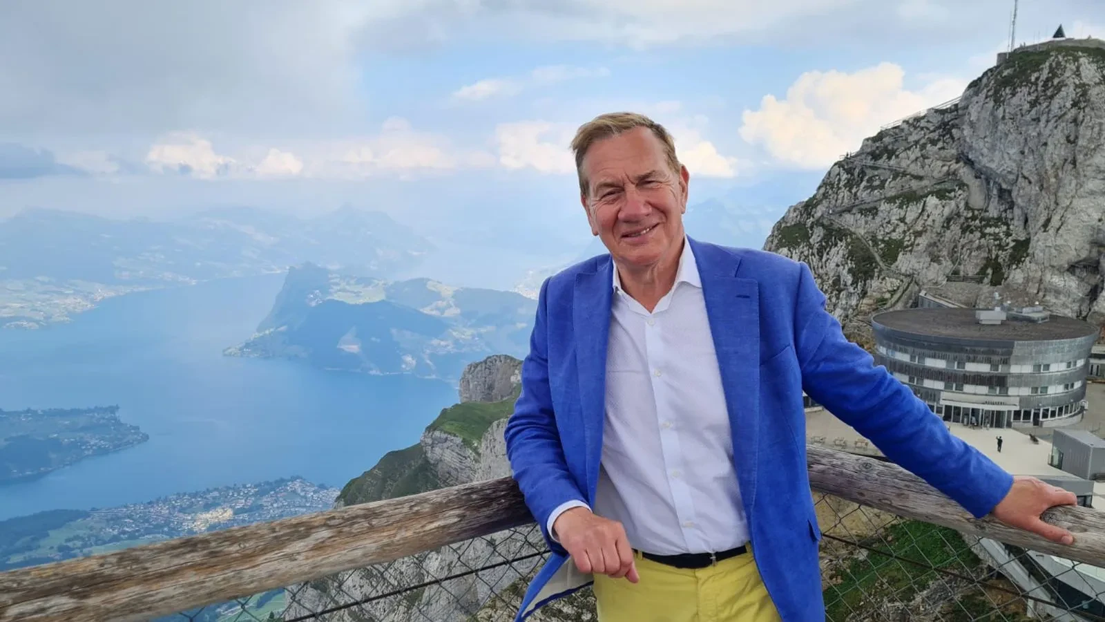 Michael Portillo stood overlooking the sea from a cliff side