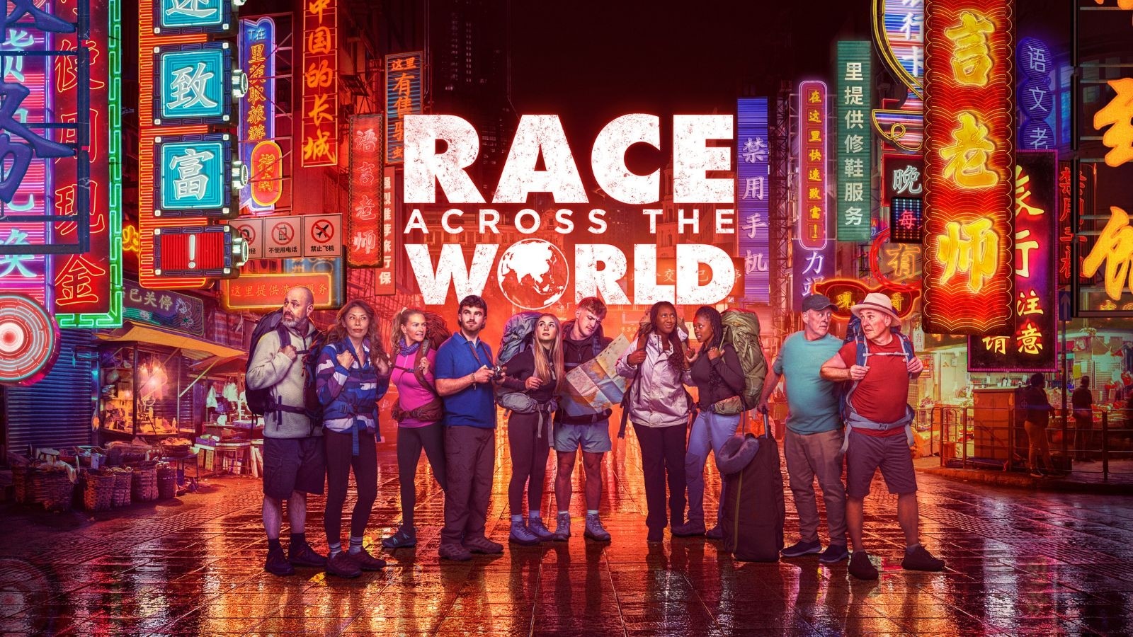 Competitors in Race Against the World stood with rucksacks on in an Asian colourful city street