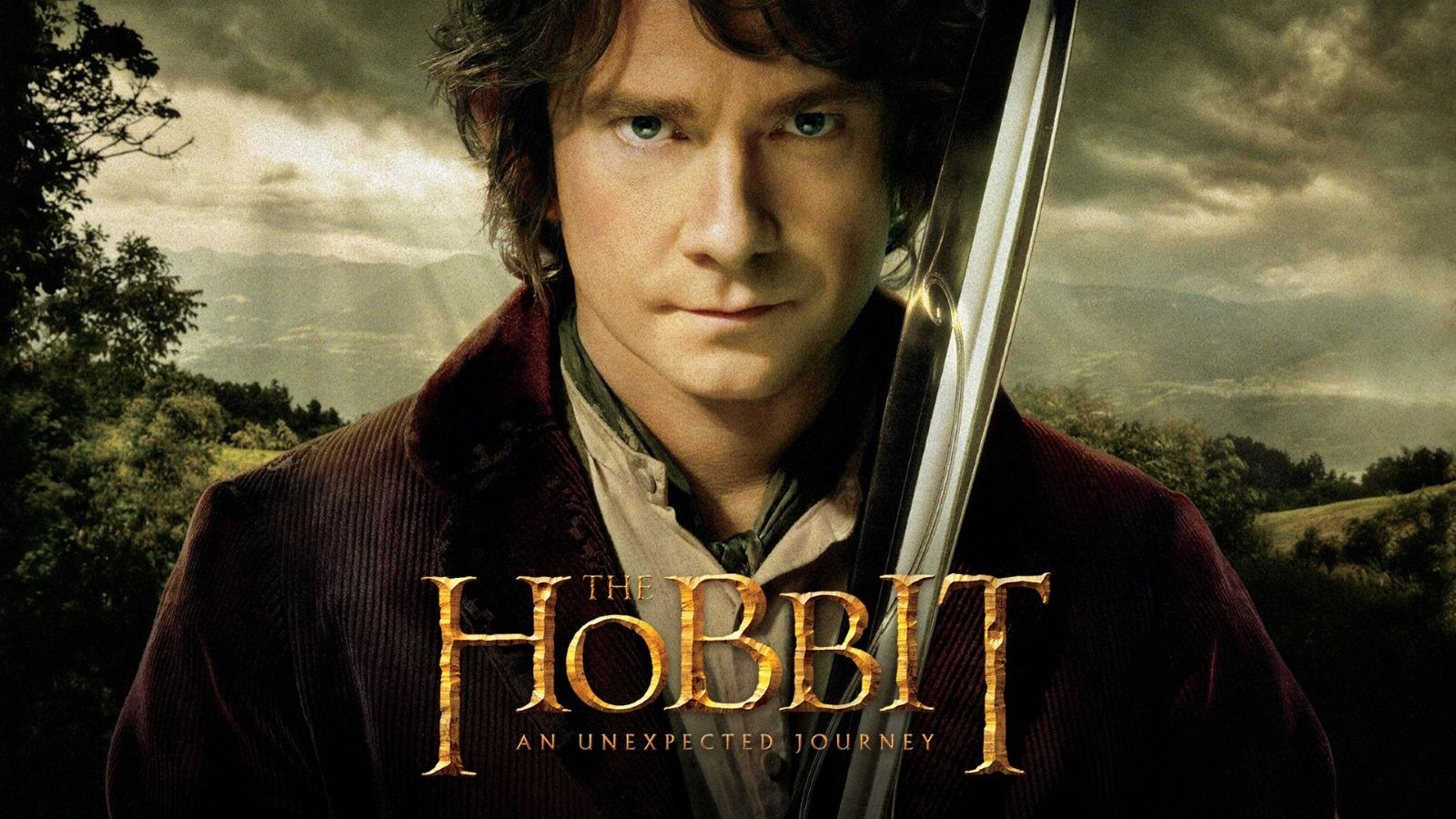 A hobbit holding a sword with a stormy scene behind him