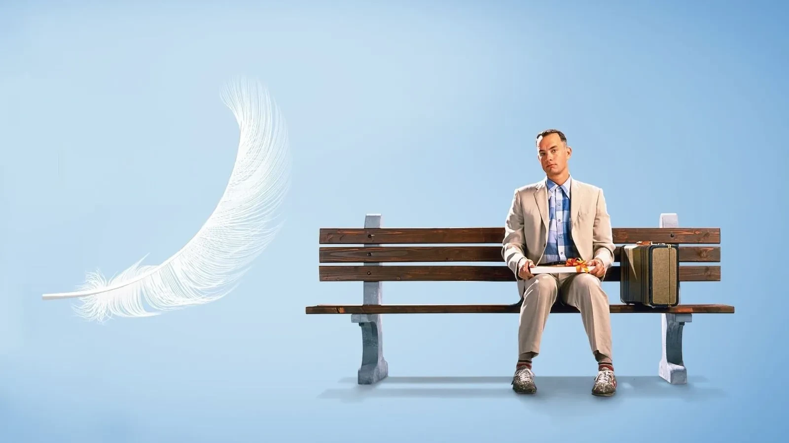 A man sat on a bench with blue in the background and moon