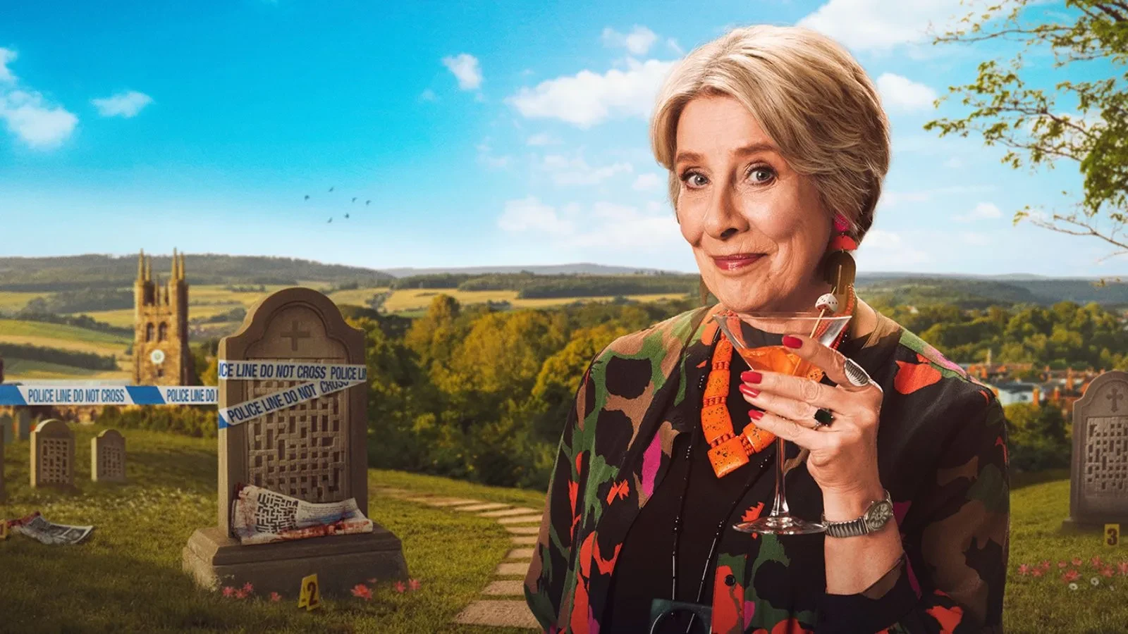 A blonde women in her 70s holding a cocktail with a gravestone behind her covered in police do not cross tape.