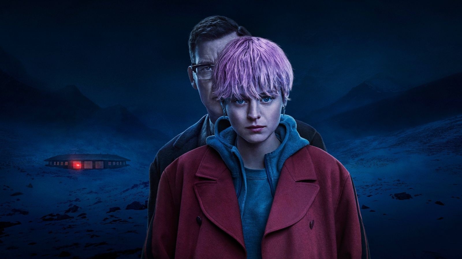 A women in a red coat with short pink hair and a man standing very closely behind her. A snowy a scene in the background with a mysterious red light emitting from a building