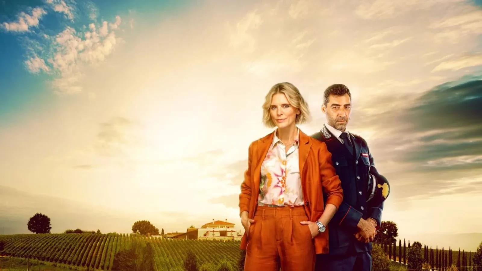 A women in a red suits with an Italian officer next to her and a nice sunny background