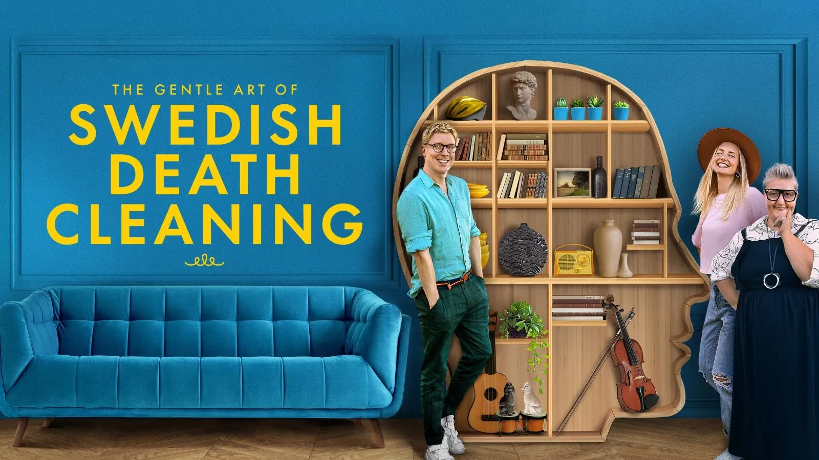 Three people stood my a face shaped bookshelf with a blue sofa to the left and blue wallpaper. Yellow writing reads The Gentle Art of Swedish Death Cleaning