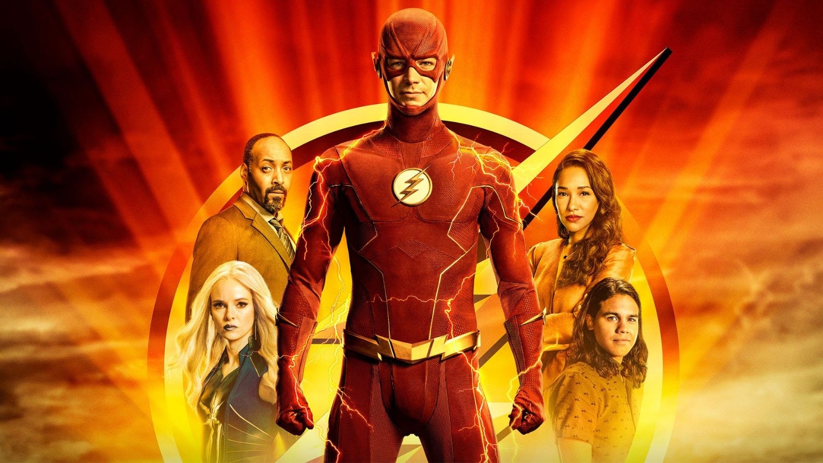 Man dressed as a superhero with a red suit and a golden lightening bolt. Other people stood in gold and orange lighting behind him