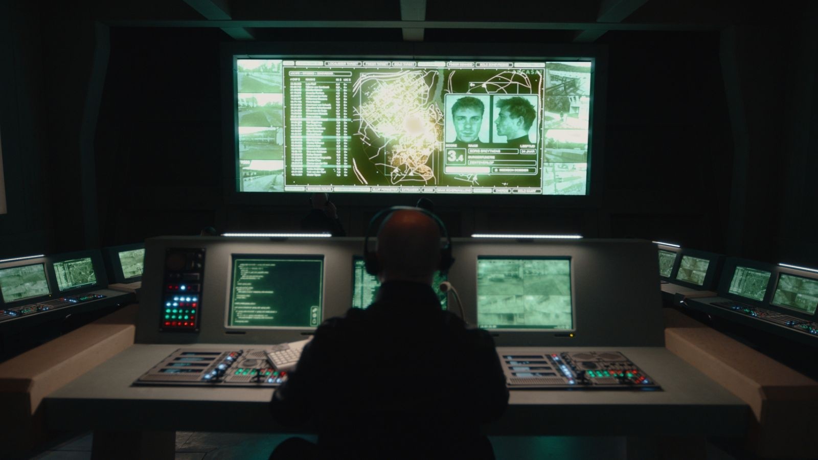 A person sat at a big computer monitor