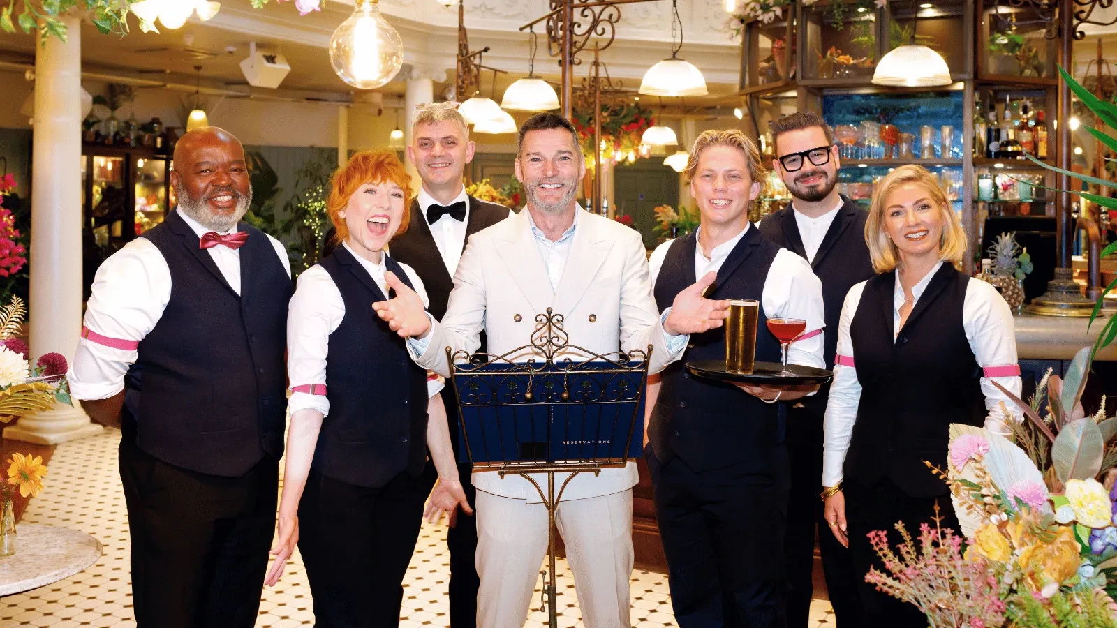 Fred Siriex and waiters stood in the opening of a restaurant for First Dates