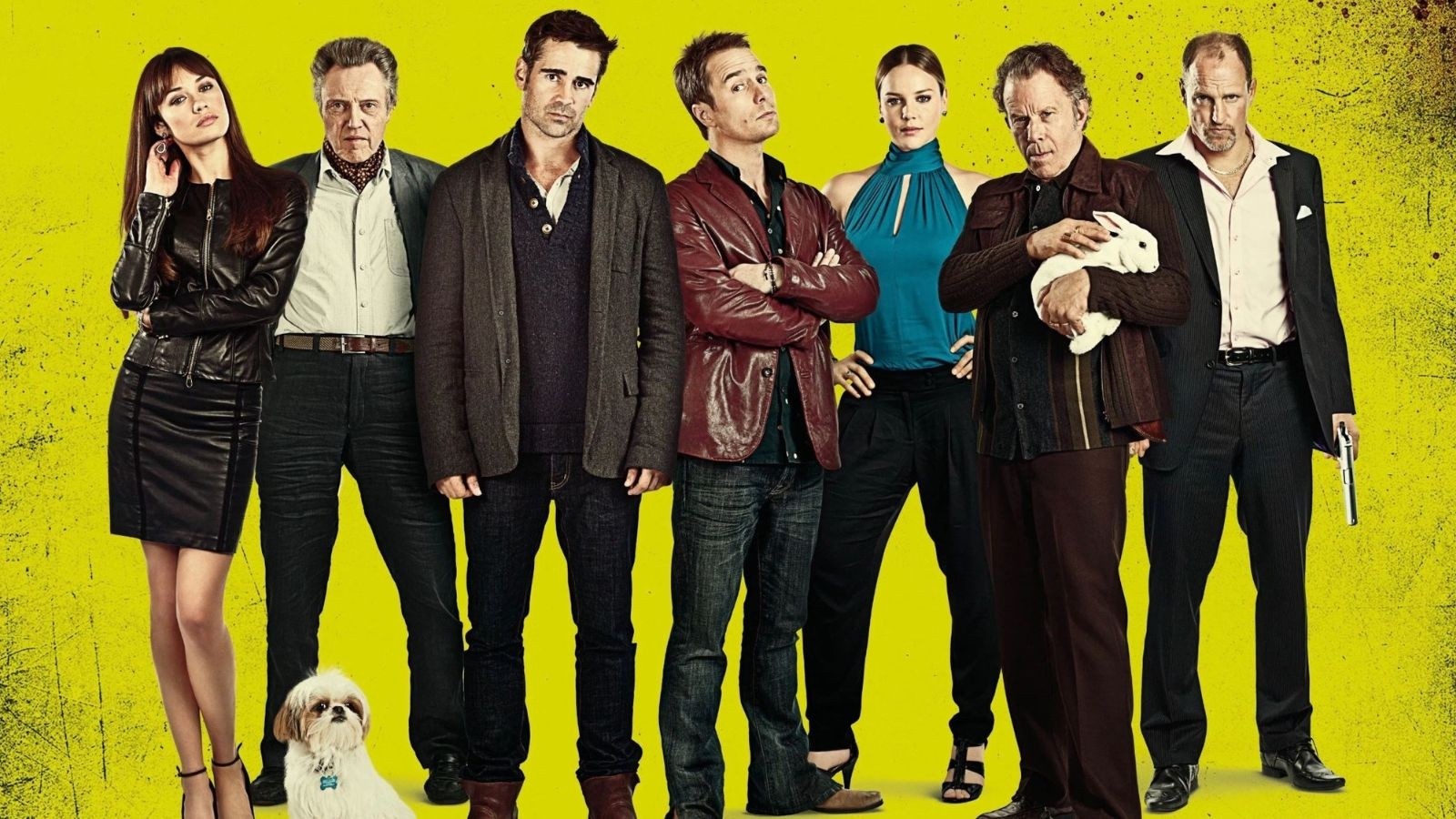 Smartly dressed criminals, 5 men and two women stood against a yellow background with a dog in front of them. One man holding a gun and another a white rabbit.