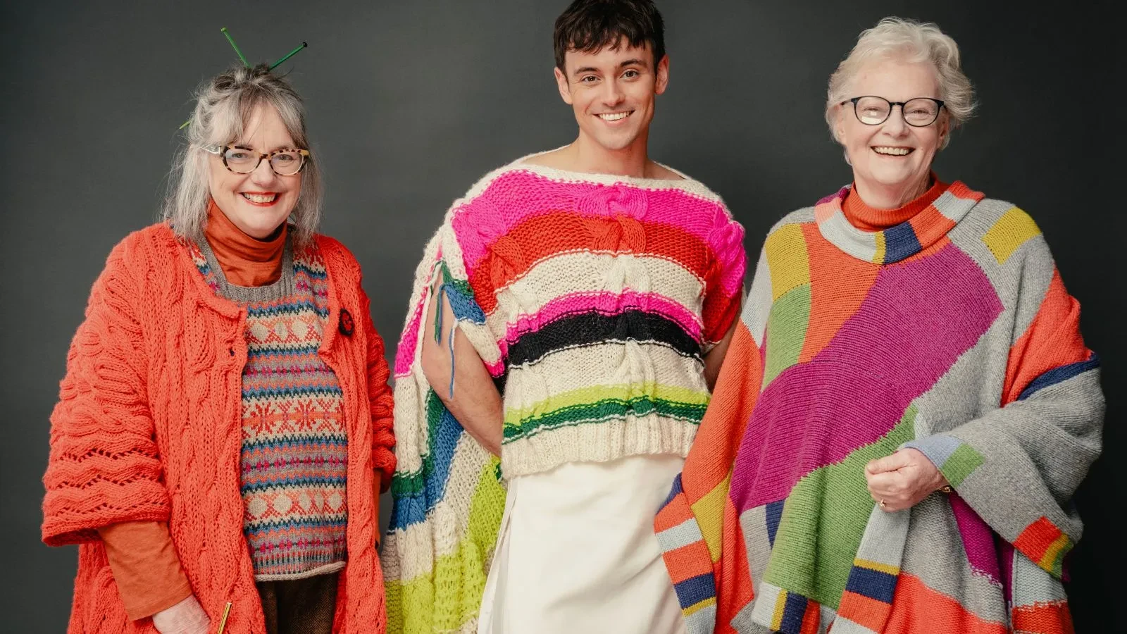Tom Daley, Di Galpin and Sheila Greenwell wearing woollen jumpers in the show A Game of Wool