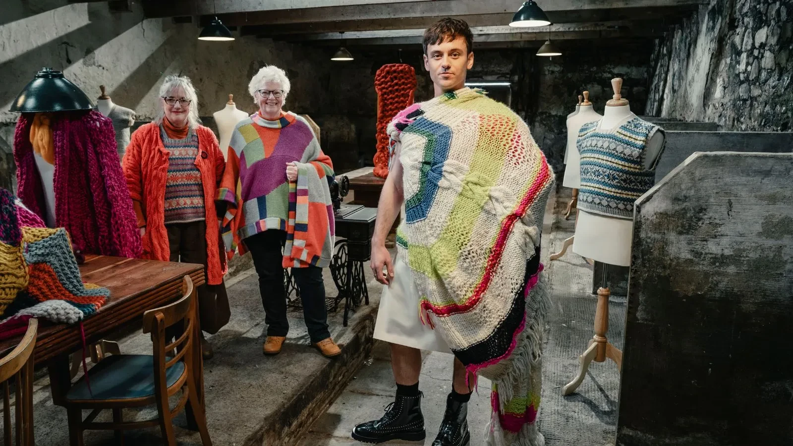Tom Daley, Di Galpin and Sheila Greenwell wearing woollen jumpers in the show A Game of Wool