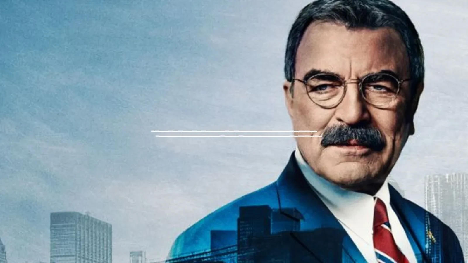 A man with a thick moustache and glasses in his late fifties wearing a blue suit with a red tie against a blue background