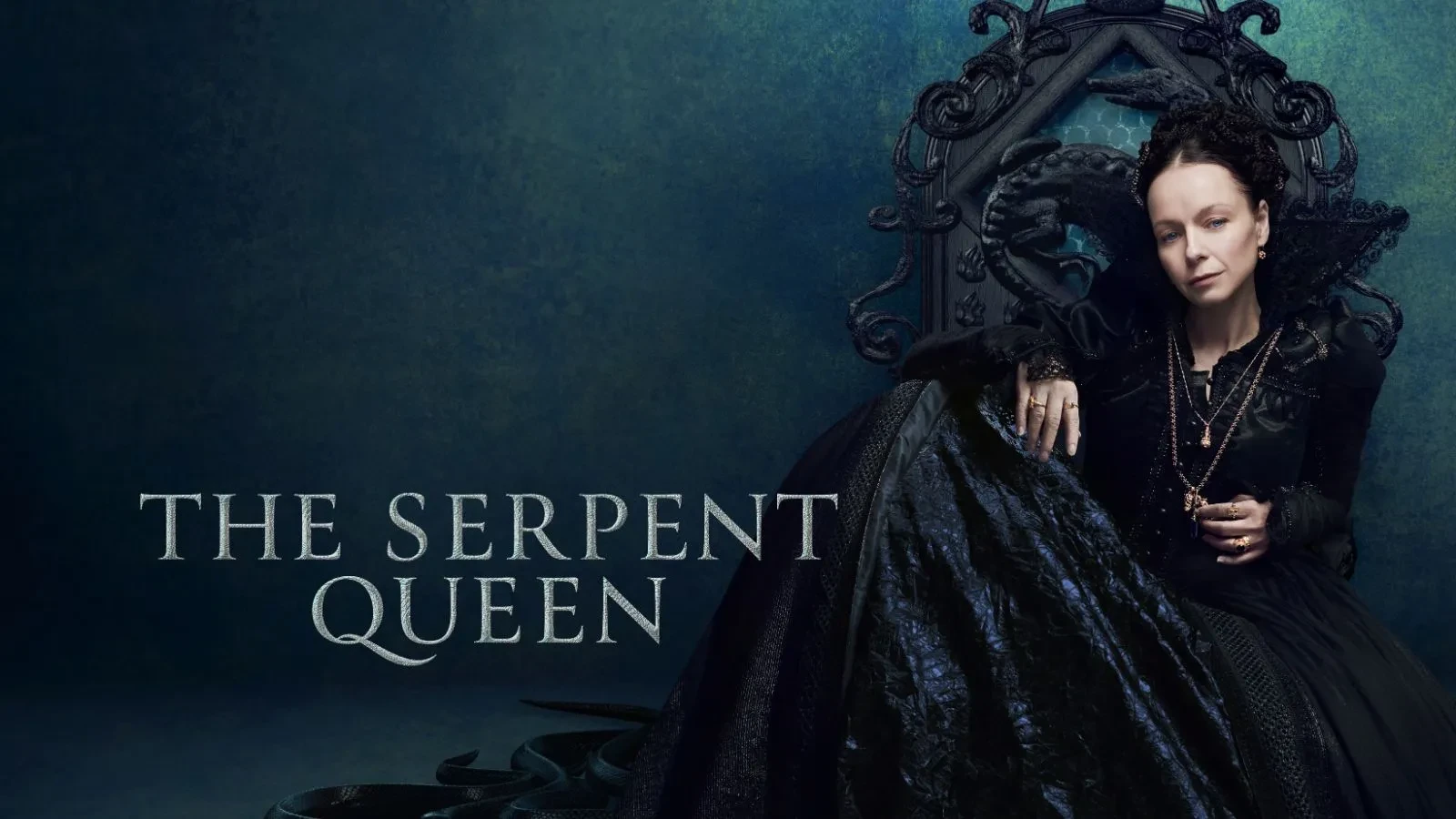 Samantha Horton in a 16th Century French black dress sat on a black throne against a dark blue background in the drama serpent queen